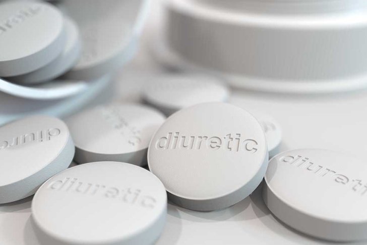 Close-up shot of pills with stamped DIURETIC text on them. 3D rendering