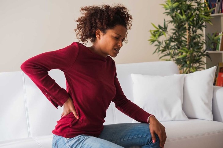 Young black woman suffer back pain cramp