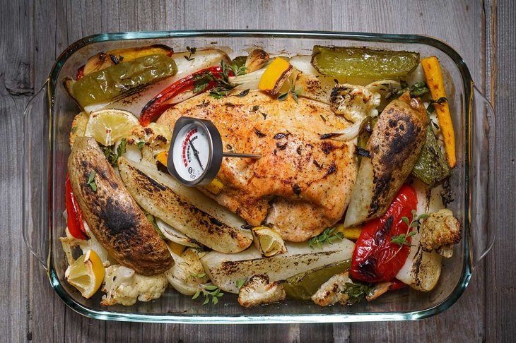 Roasted Turkey Breast with Mixed Vegetables/ Wood Background