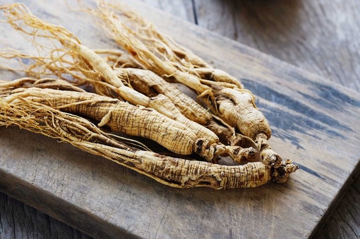 Ginseng root on wooden background, Herbs for health.