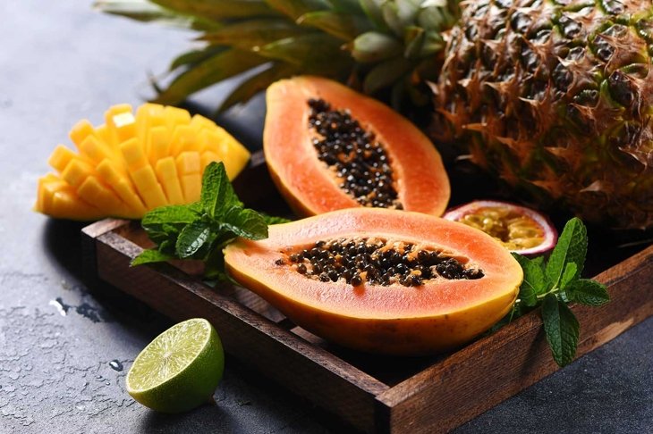 Papaya fruit, sweet ripe fresh papaya, mango, pine apple, raw vegan food, tropical fruits