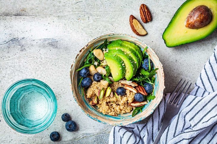 Vegan quinoa salad with berries, avocado and nuts. Healthy vegan food.