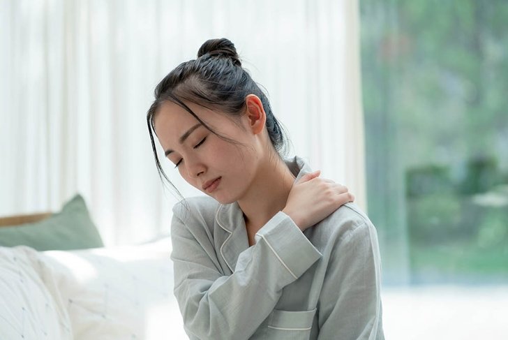 Depressed young asian woman in bedroom.