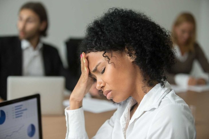 African american businesswoman feeling unwell suffering from headache migraine touching forehead at team meeting, upset black woman employee frustrated by business problem or work stress, head shot