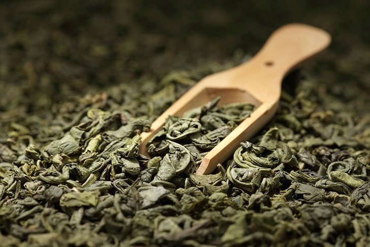 Tea leaves background/ green tea/  wooden scoop/